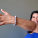 female hand modeling purple charoite stretch bracelet