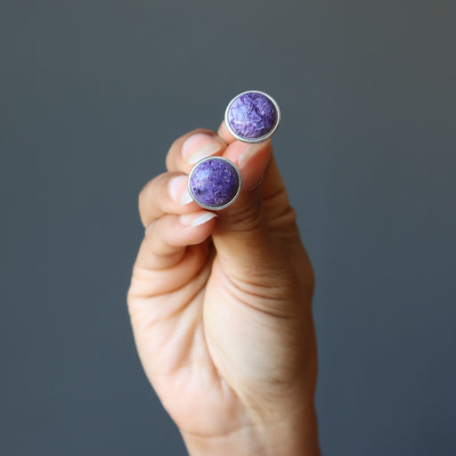 hand holding purple Charoite Cufflinks in Silver 
