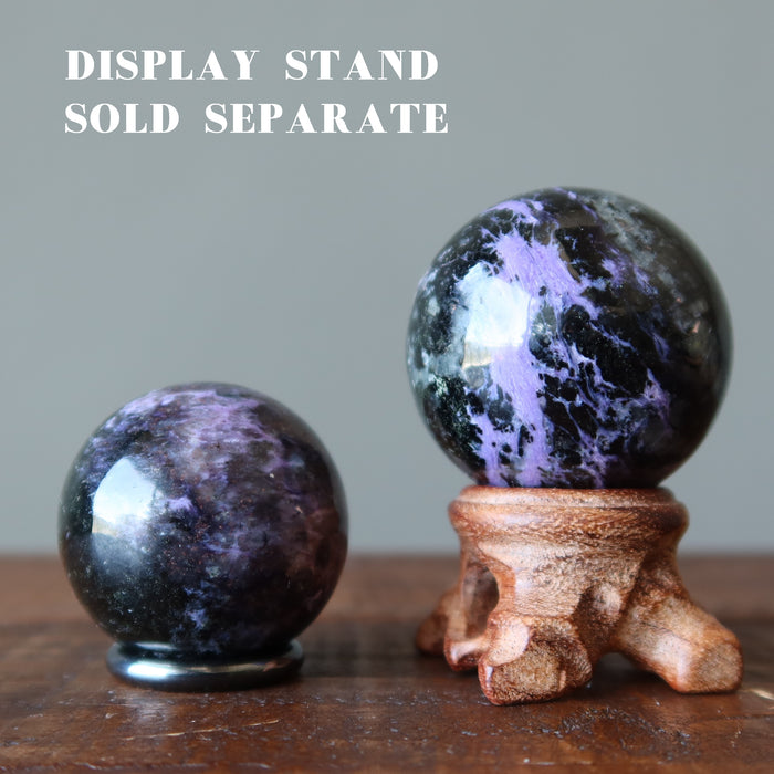 two Purple Charoite Spheres displaying on the stands 