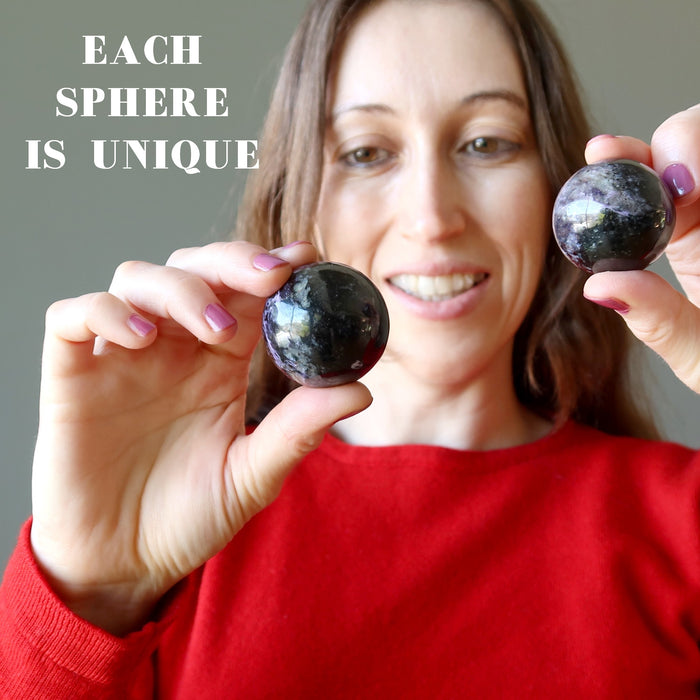 female model holding on each hand unique Purple Charoite Spheres 