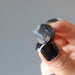 hand holding rocky brown chelyabinsk meteorite 
