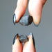 hand holding two chelyabinsk meteorites