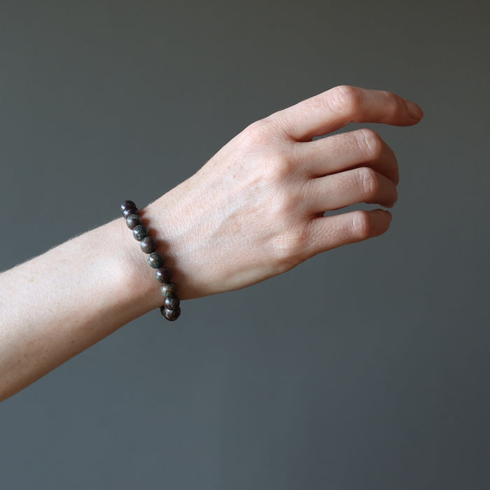 female hand model wearing chrysocolla cuprite bracelet