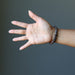 female hand model wearing chrysocolla cuprite bracelets