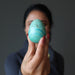 woman holding chrysocolla egg