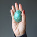 hand holding chrysocolla egg