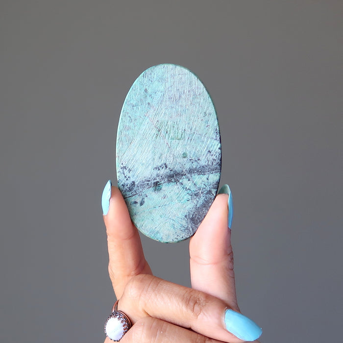 showing the back of the blue-green and black chrysocolla oval cabochon