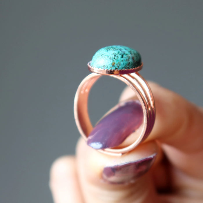 hand holding chrysocolla copper ring