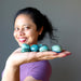 sheila of Satin Crystals holding Chrysocolla Tumbled Stones