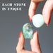 hands holding two chrysoprase tumbled stones
