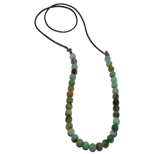 Chrysoprase round beads hang from a brown cotton cord necklace long enough to wear without a clasp