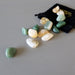 set of 7 yellow citrine and green aventurine tumbled stones and black satin crystals pouch