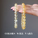 hand holding a light and a dark yellow citrine bracelet to show colors vary