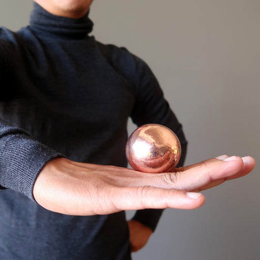 balancing a copper sphere on the back of the hand