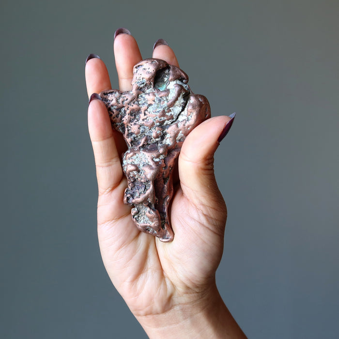 hand holding Raw Copper Metal Sculpture