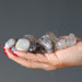 rutilated quartz tumbled stones in hands