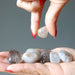 rutilated quartz tumbled stones in hands