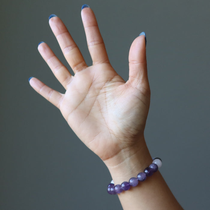hand wearing blue lace agate, rose quartz, amethyst stretch bracelet for sleep