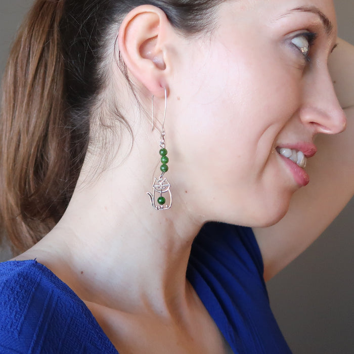 female model wearing sterling silver cat and green diopside gemstone earrings displaying the right side