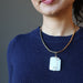 model wearing wavy rectangle white Dolomite stone wrapped in gold plated wire pendant hangs on Gold plated choker