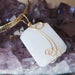 wavy rectangle white Dolomite stone wrapped in gold plated wire pendant hangs on Gold plated choker on amethyst cluster