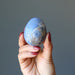 hand holding blue dumortierite crystal egg