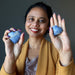 woman holding two dumortierite crystal heart