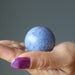 blue Dumortierite Sphere on the palm