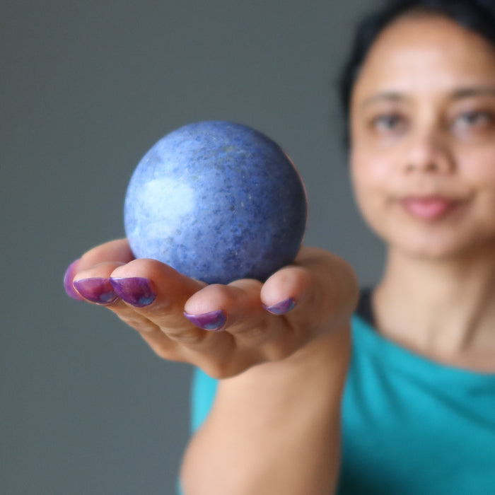 hand holding blue Dumortierite Sphere