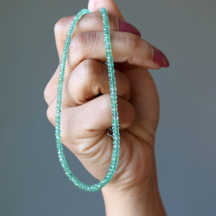 hand holding Emerald Necklace
