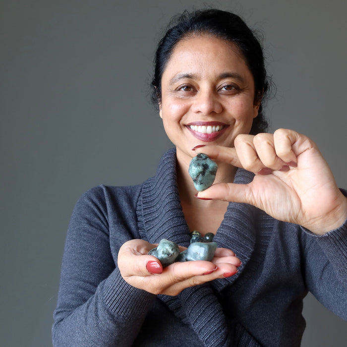 tumbled emerald stones at throat chakra