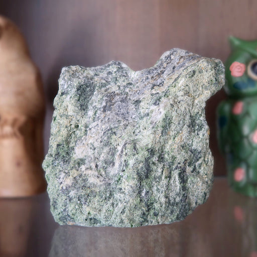 rough green epidote standing mineral stone on shelf