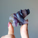 fingers holding  Carved Rainbow Fluorite Bear Statue