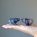 two  Carved Rainbow Fluorite Bear Statues on the model palm
