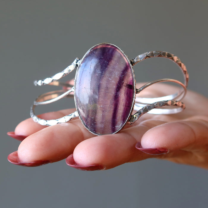 hand holding Purple Fluorite Cuff Bracelet 