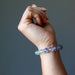 hand wearing a rainbow fluorite beaded stretch bracelet