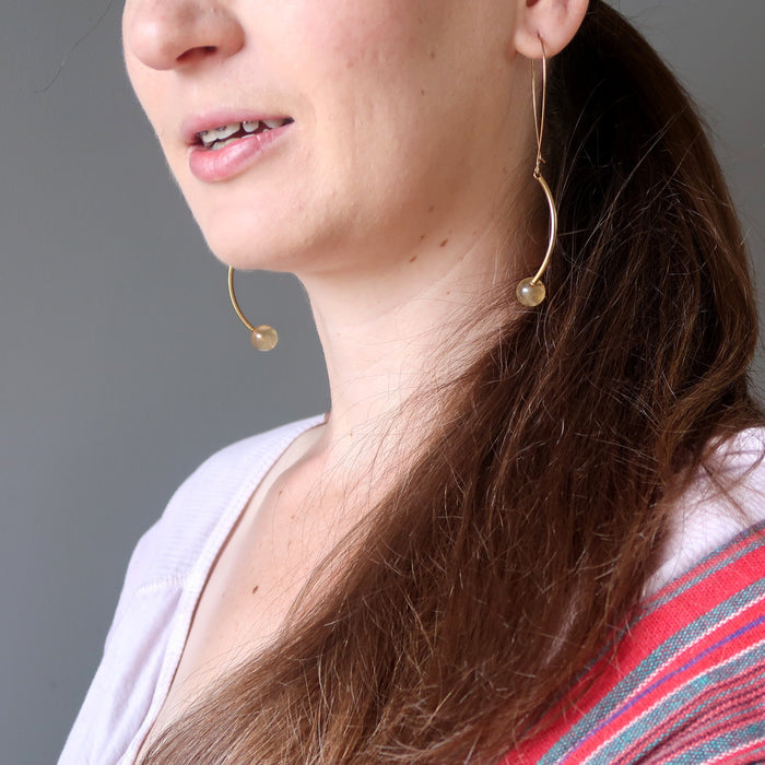 woman wearing golden fluorite earrings