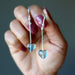 hand holding Fluorite heart Earrings on sterling silver