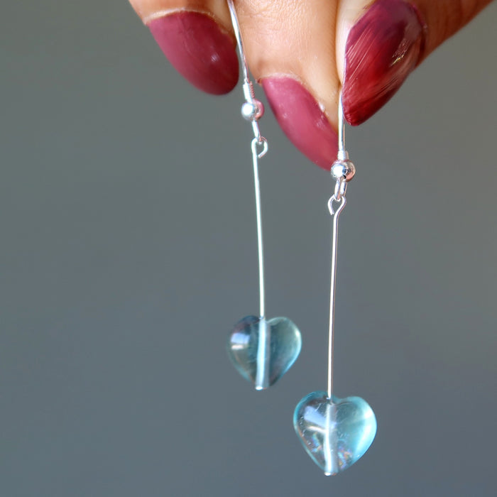 holding Fluorite heart Earrings on sterling silver