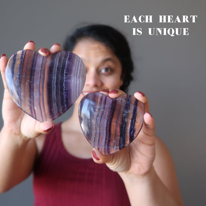 sheila of satin crystals holding Purple Fluorite Heart on each hand