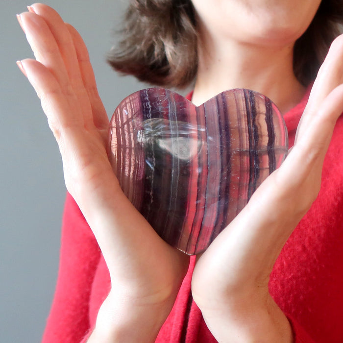 female model holding Purple Fluorite Heart