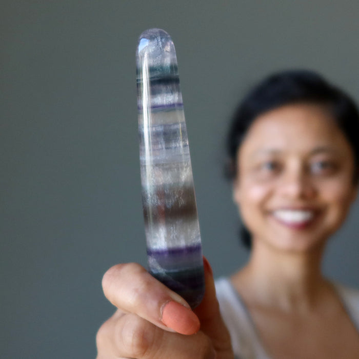 sheila of satin crystals holding rainbow fluorite tapered massage wand