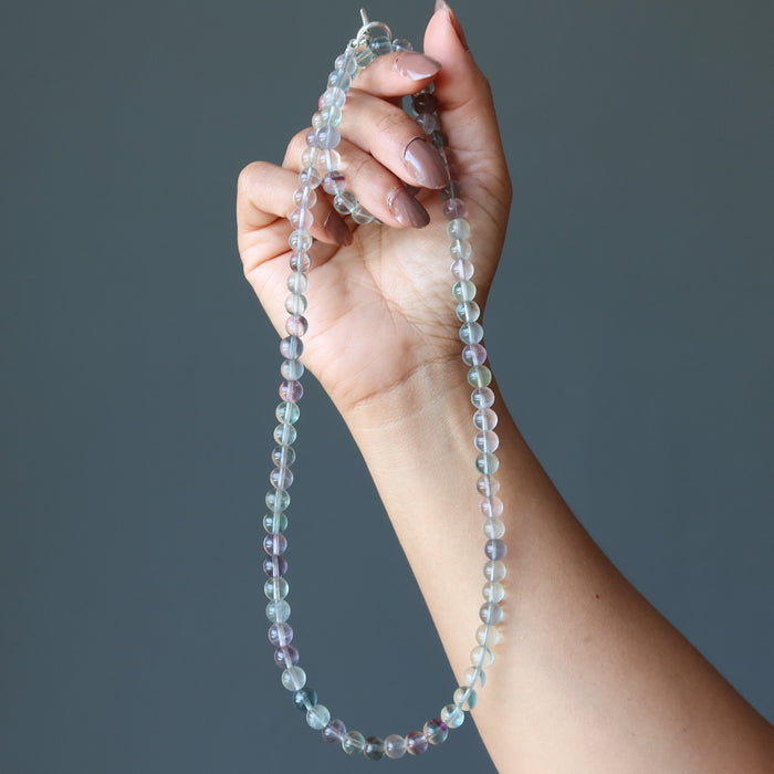 holding a Beaded Rainbow Fluorite Necklace