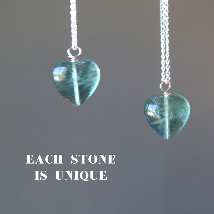 displaying two blue Fluorite heart pendants hang from sterling silver chain necklaces