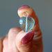 holding a blue Fluorite heart pendant