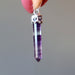 holding Purple Rainbow Fluorite Pendant on Sterling Silver