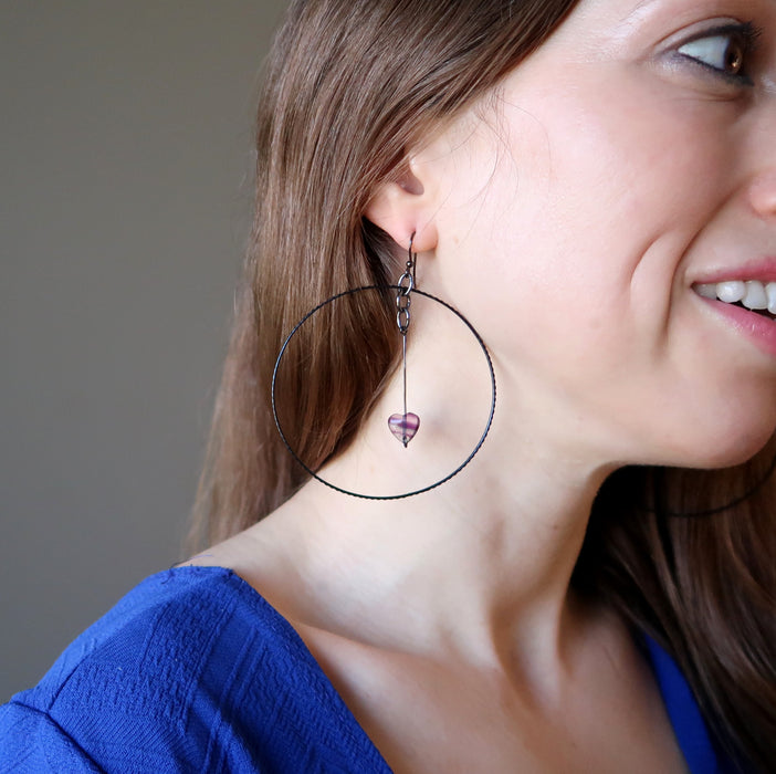 woman modeling purple fluorite heart hoop earrings