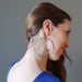 woman modeling purple fluorite heart hoop earrings