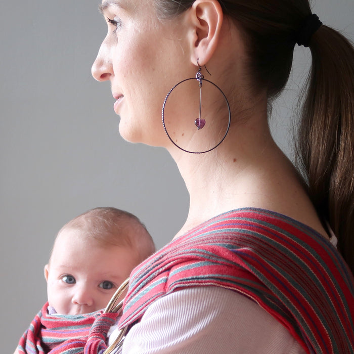 mother modeling purple fluorite heart hoop earrings