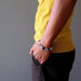 man's hand in pockets wearing rainbow fluorite beaded stretch bracelet 